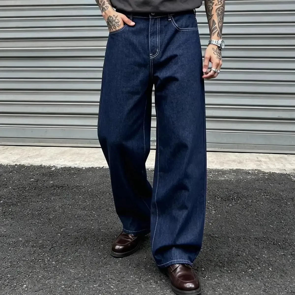Denim Blue Dark Topstitched Wide-Leg Jeans Are the Same for Men and Women. They Are High-Waisted Loose and Floor-Length. They A